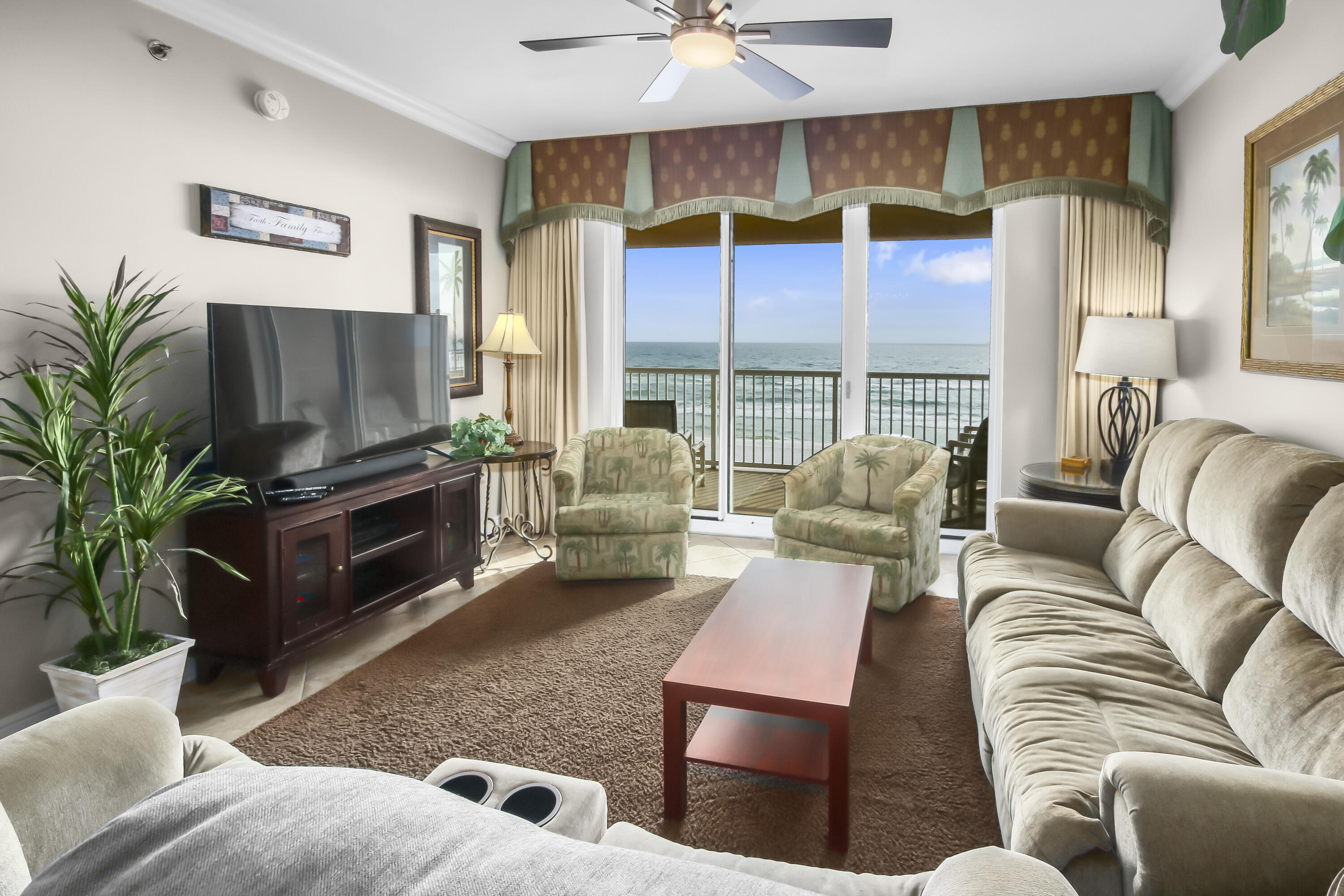 1150 Santa Rosa Boulevard, Unit 502 Fort Walton Beach, FL 32548 - Photo 3 of 43 a living room with furniture ceiling fan and a flat screen tv