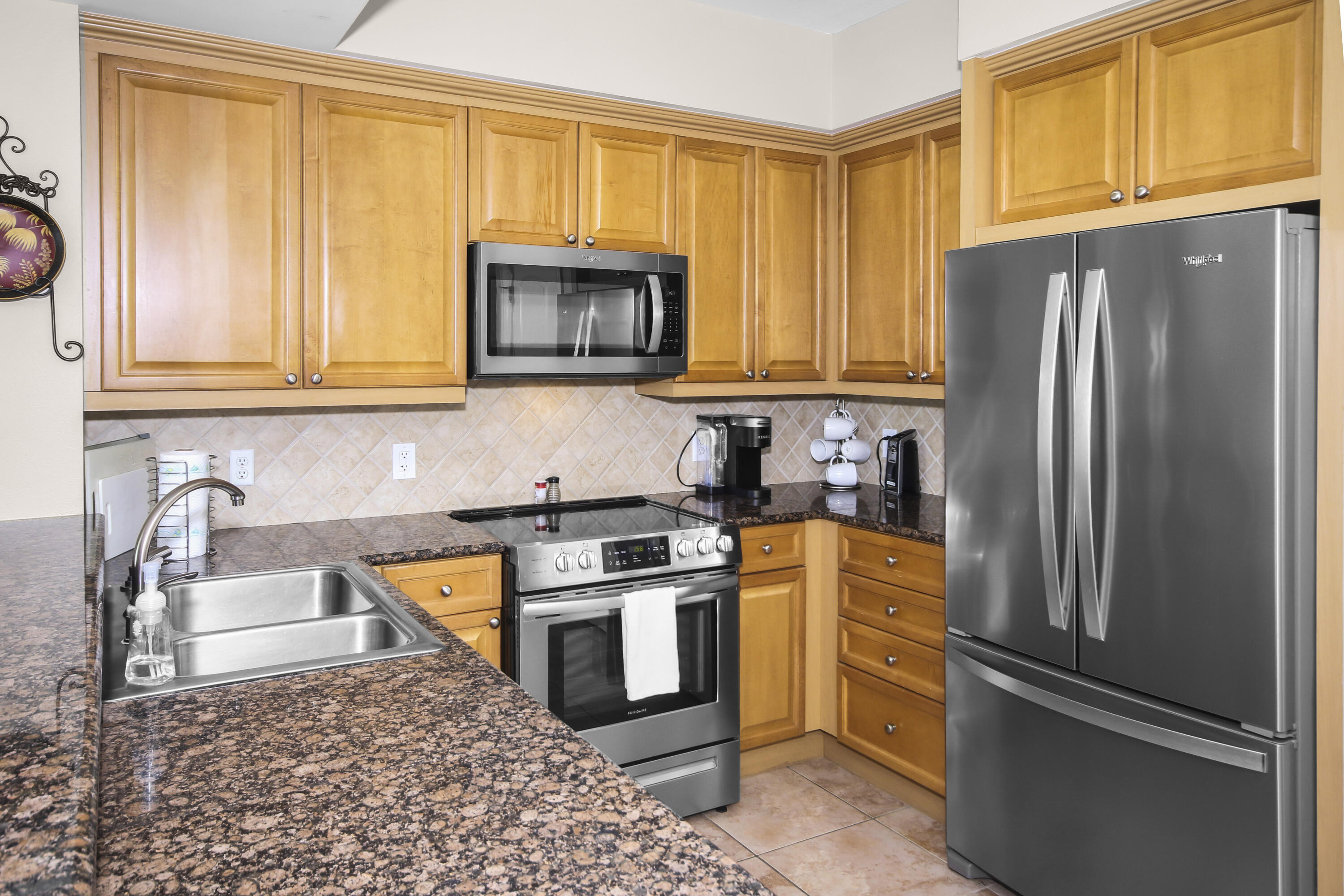 1150 Santa Rosa Boulevard, Unit 502 Fort Walton Beach, FL 32548 - Photo 9 of 43 a kitchen with stainless steel appliances granite countertop a refrigerator stove top oven and sink