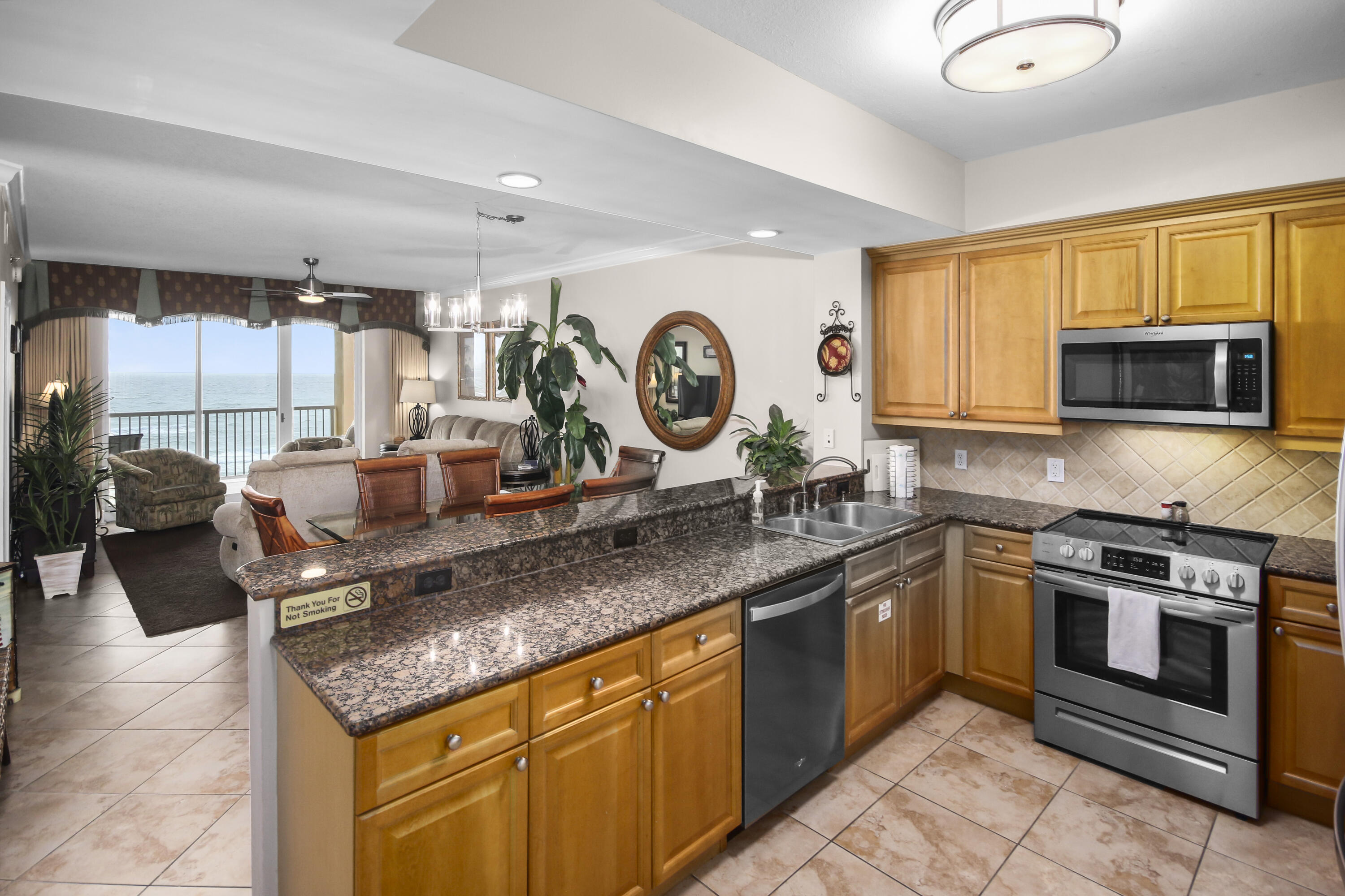 1150 Santa Rosa Boulevard, Unit 502 Fort Walton Beach, FL 32548 - Photo 10 of 43 a kitchen with stainless steel appliances granite countertop a stove a sink and a microwave