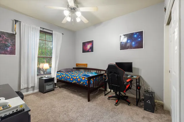 a bedroom with a bed and a window