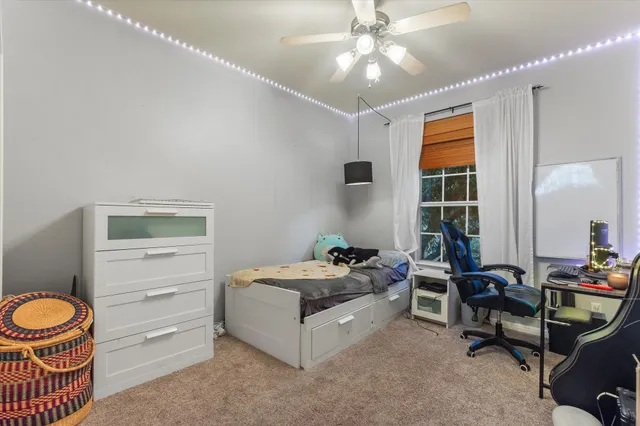 a bedroom with furniture and a window