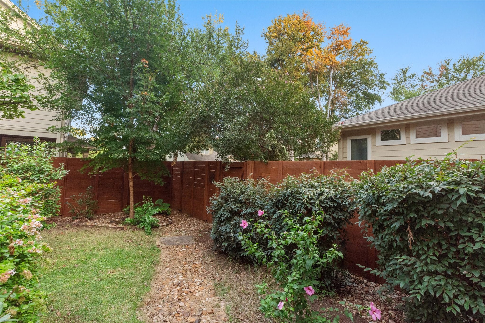 11000 Anderson Mill Road, Unit 34 Austin, TX 78750 - Photo 15 of 18 a view of a house with a yard and garden