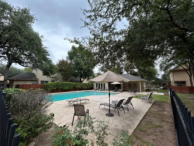 an outdoor space with patio and white umbrellas