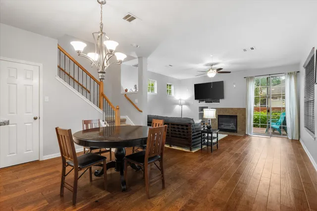 a dining room with furniture a chandelier and wooden floor
