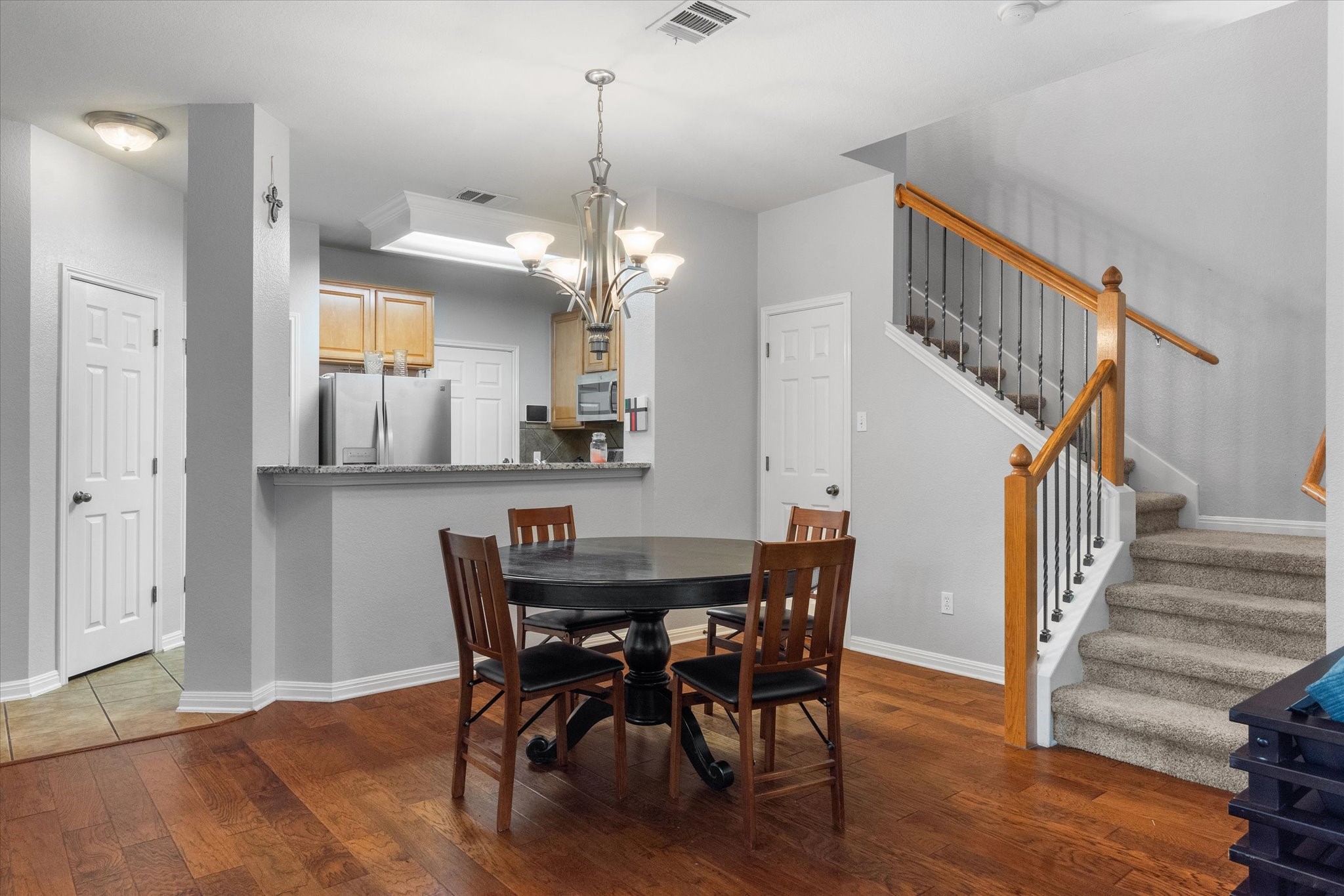 11000 Anderson Mill Road, Unit 34 Austin, TX 78750 - Photo 5 of 18 a view of a dining room with furniture and wooden floor