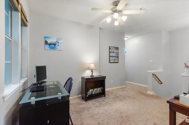 a room with furniture and a chandelier fan