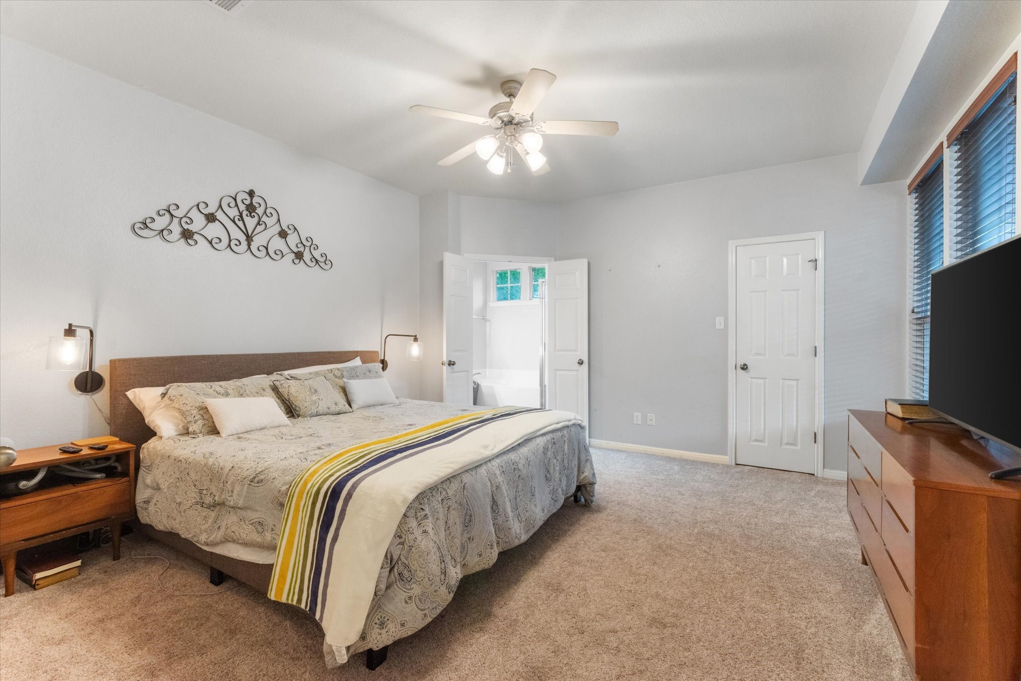11000 Anderson Mill Road, Unit 34 Austin, TX 78750 - Photo 9 of 18 a spacious bedroom with a bed and a flat screen tv