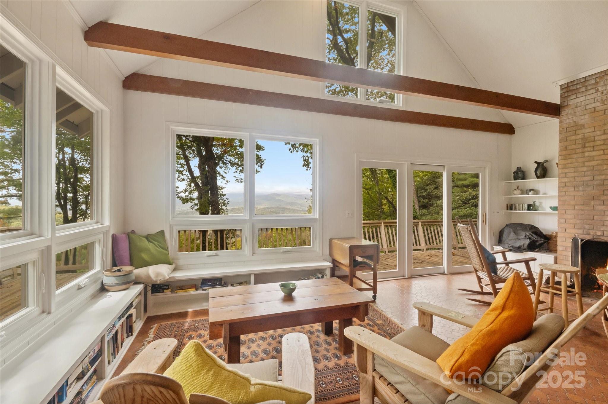 909 Green Hill Road Brevard, NC 28712 - Photo 12 of 44 a living room with furniture large windows plants and kitchen view