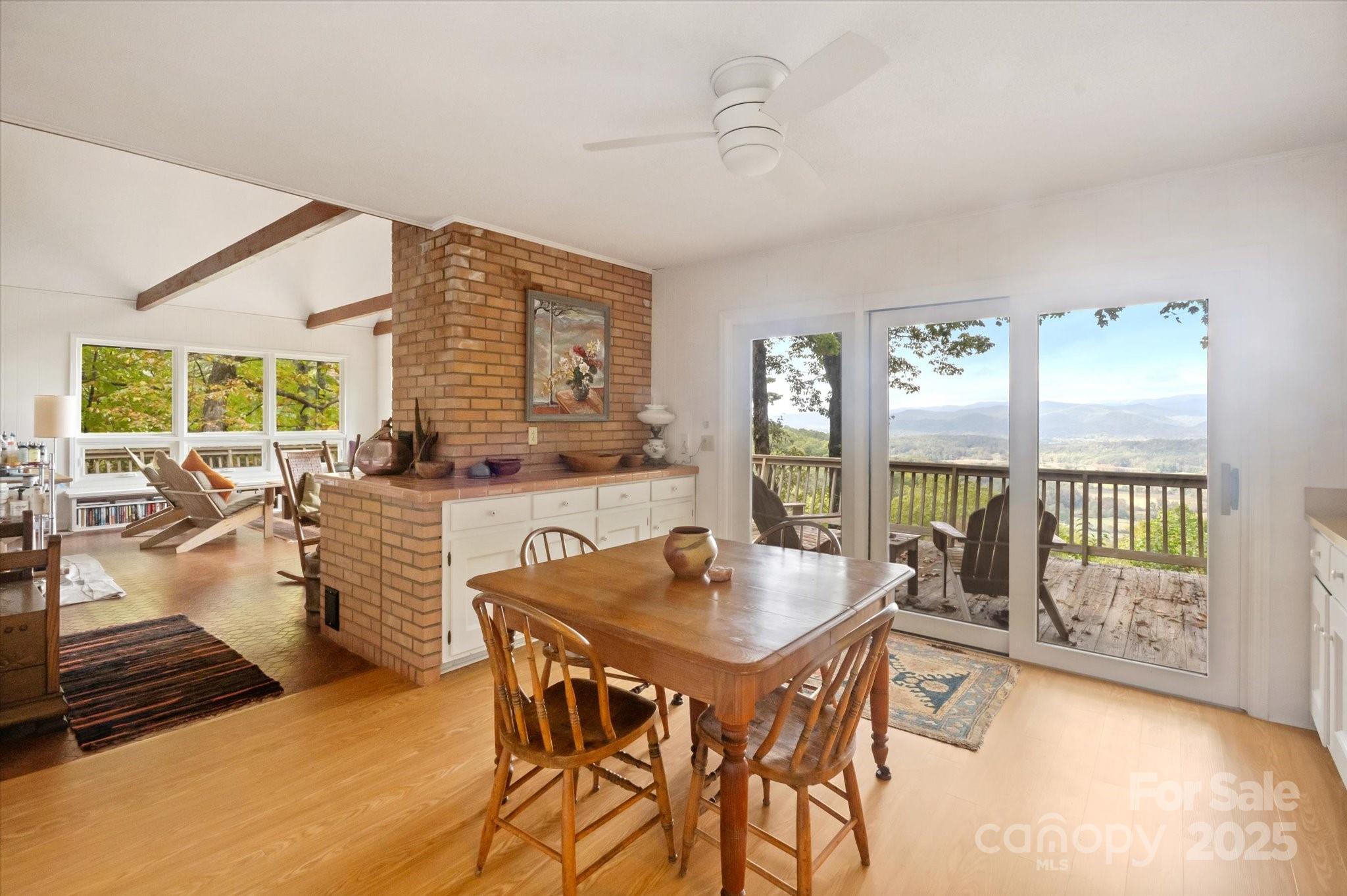 909 Green Hill Road Brevard, NC 28712 - Photo 21 of 44 a dining room with furniture a chandelier and wooden floor