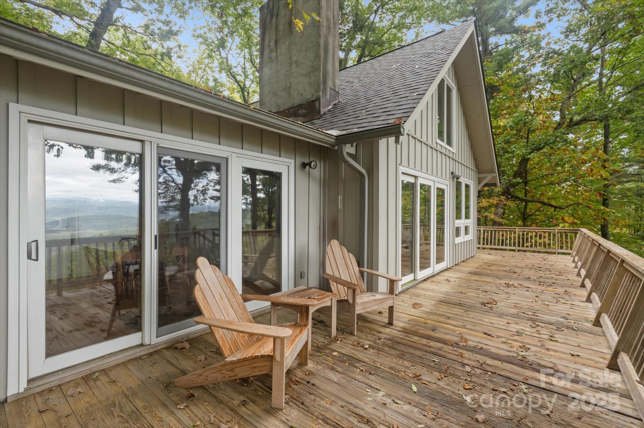 909 Green Hill Road Brevard, NC 28712 - Photo 3 of 44 a view of a patio with table and chairs and wooden floor