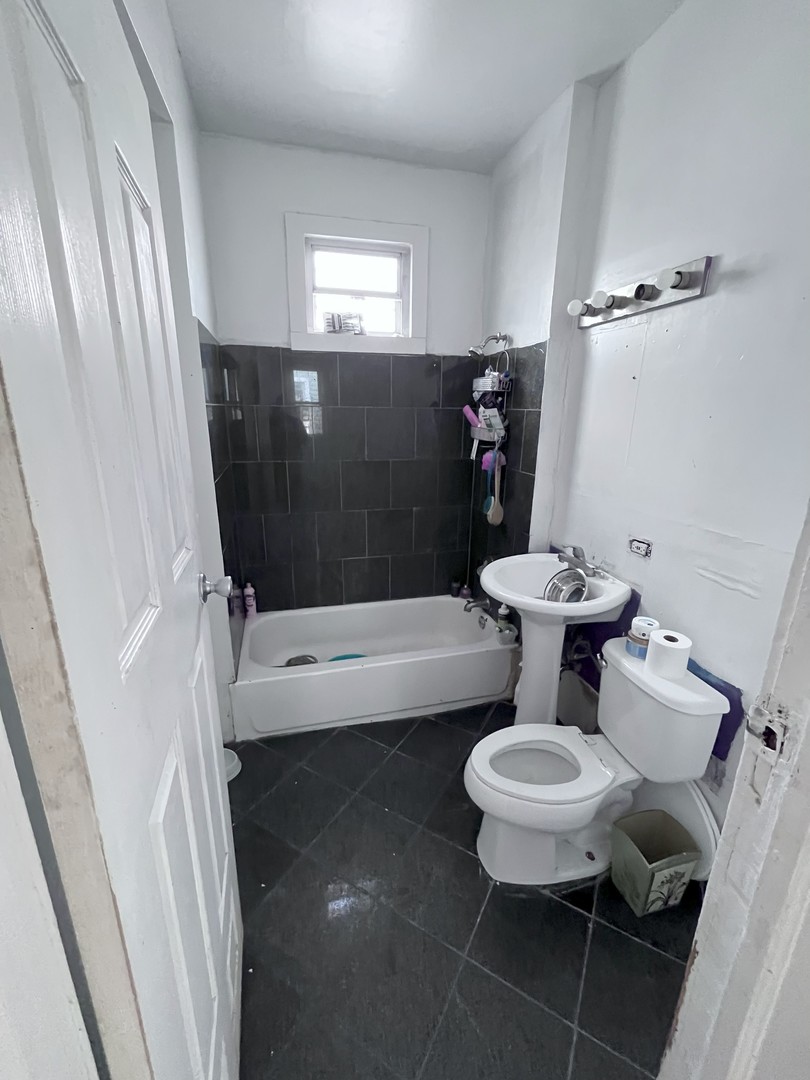 2103 West 52nd Street Chicago, IL 60609 - Photo 6 of 9 a bathroom with a toilet and a shower