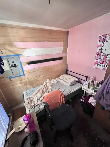 a bedroom with a bed and a couch