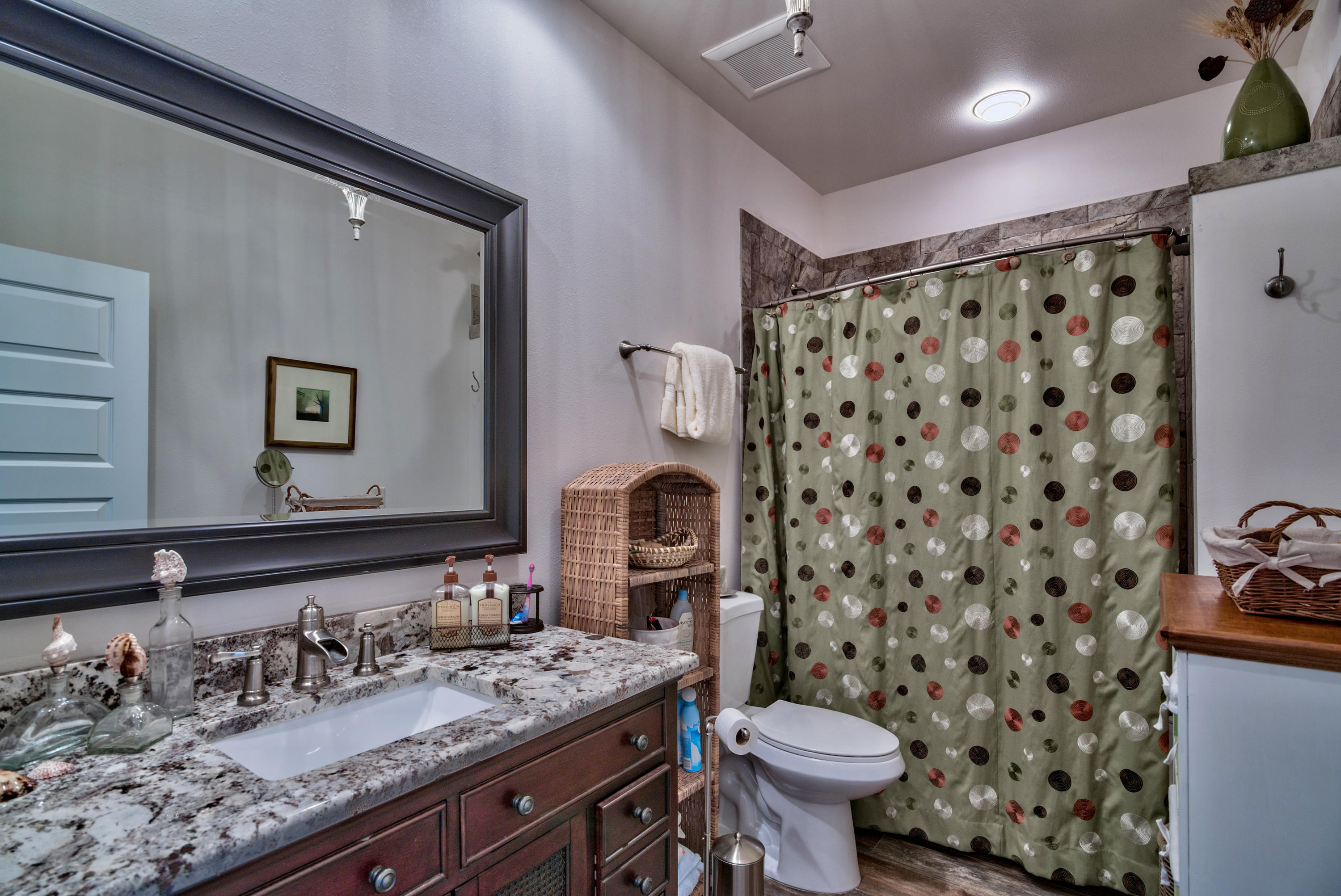 170 Sunrise Circle Santa Rosa Beach, FL 32459 - Photo 22 of 37 a bathroom with a granite countertop toilet sink and mirror