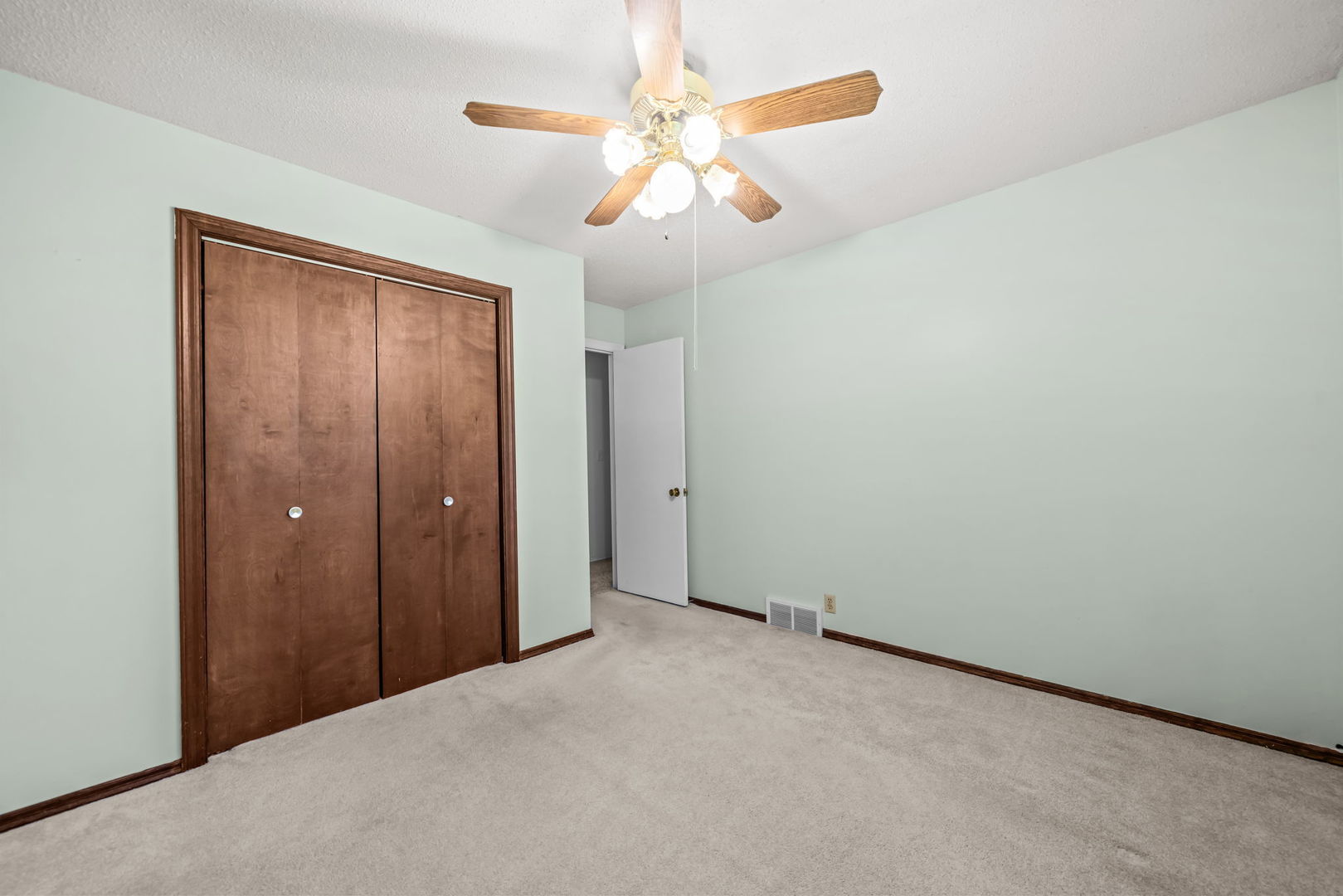 5748 South Skare Road Rochelle, IL 61068 - Photo 22 of 45 an empty room with a chandelier fan and closet