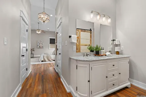 a spacious bathroom with a double vanity sink and a mirror