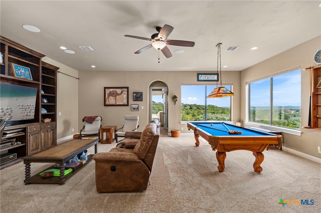 1039 Bluewater Place Spring Branch, TX 78070 - Photo 48 of 48 a living room with furniture a rug and a chandelier