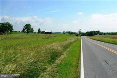 12914 Detour Road Keymar, MD 21757 - Photo 4 of 18 a view of a green field with wooden fence