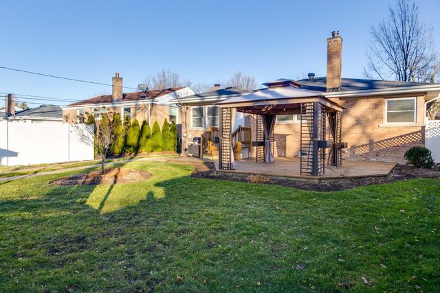 a view of a house with a backyard and a patio