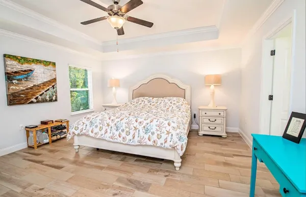 a bedroom with a bed and a chandelier