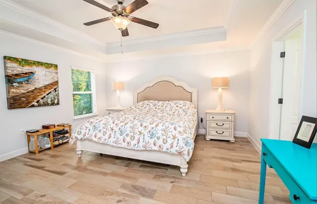 a bedroom with a bed and a chandelier