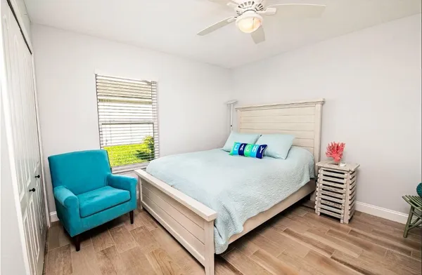 a bed sitting in a bedroom next to a window with a bedroom