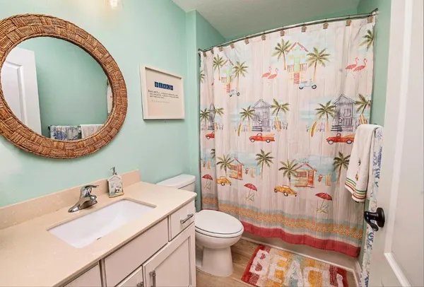 a bathroom with a sink mirror vanity and toilet