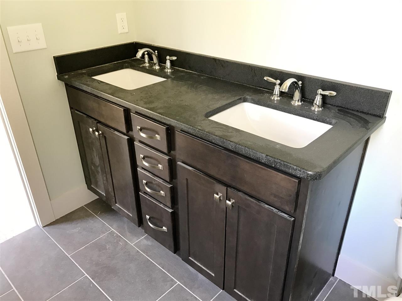 809 East Lenoir Street Raleigh, NC 27601 - Photo 11 of 20 a bathroom with a granite countertop sink and a mirror