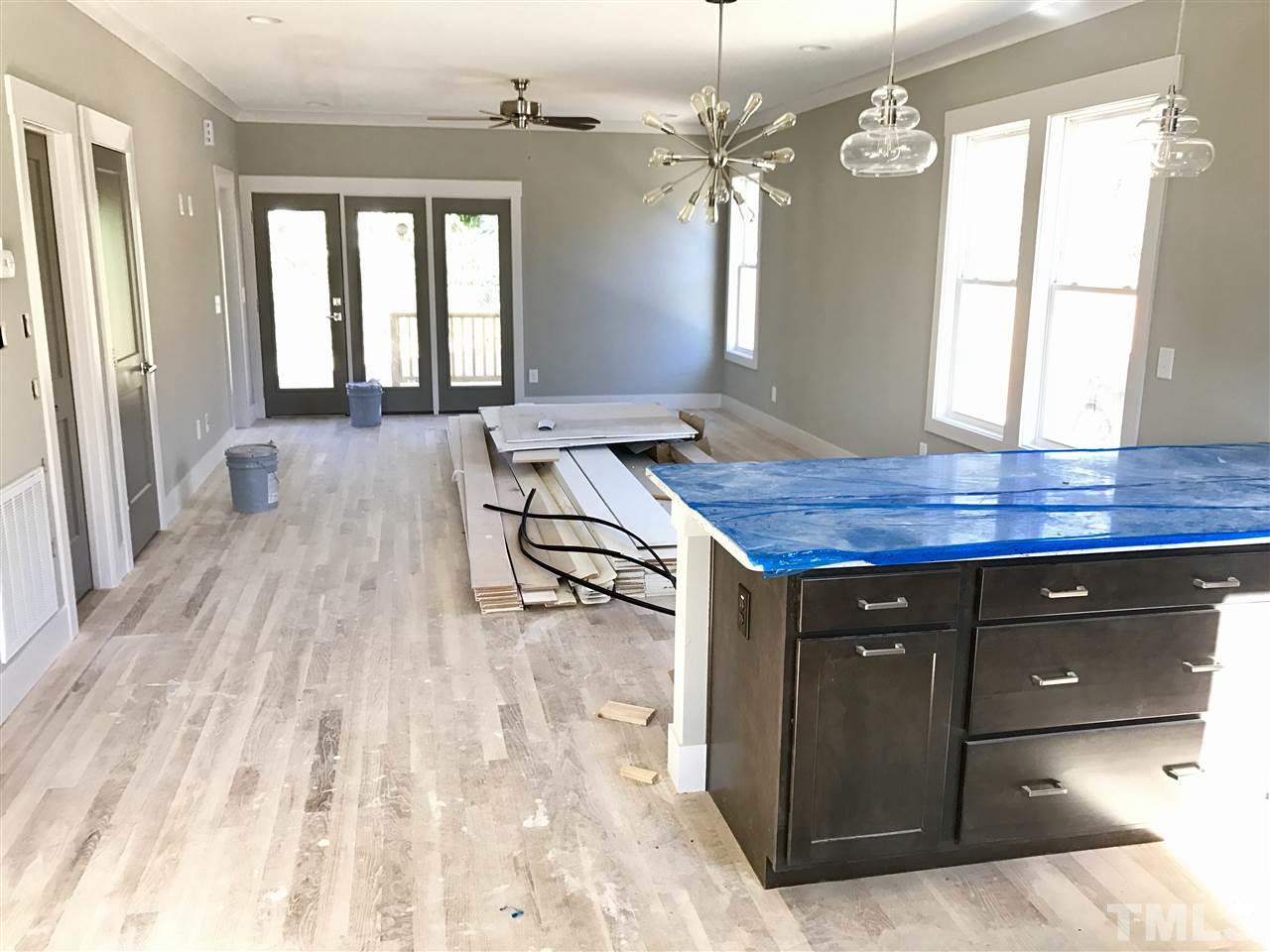 809 East Lenoir Street Raleigh, NC 27601 - Photo 3 of 20 a room with wooden floor and window
