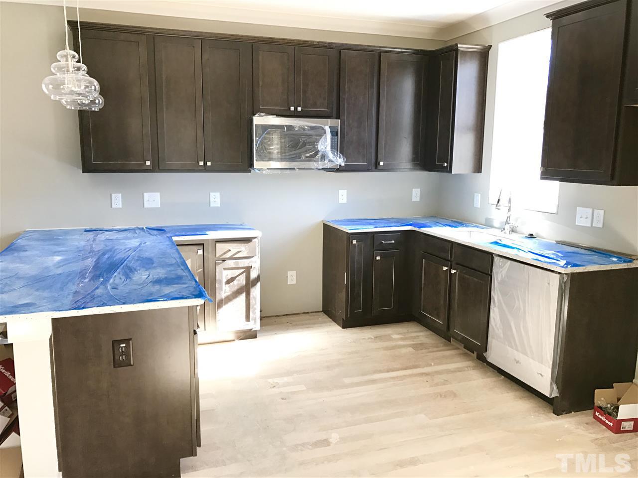 809 East Lenoir Street Raleigh, NC 27601 - Photo 4 of 20 a kitchen with a sink a microwave and cabinets