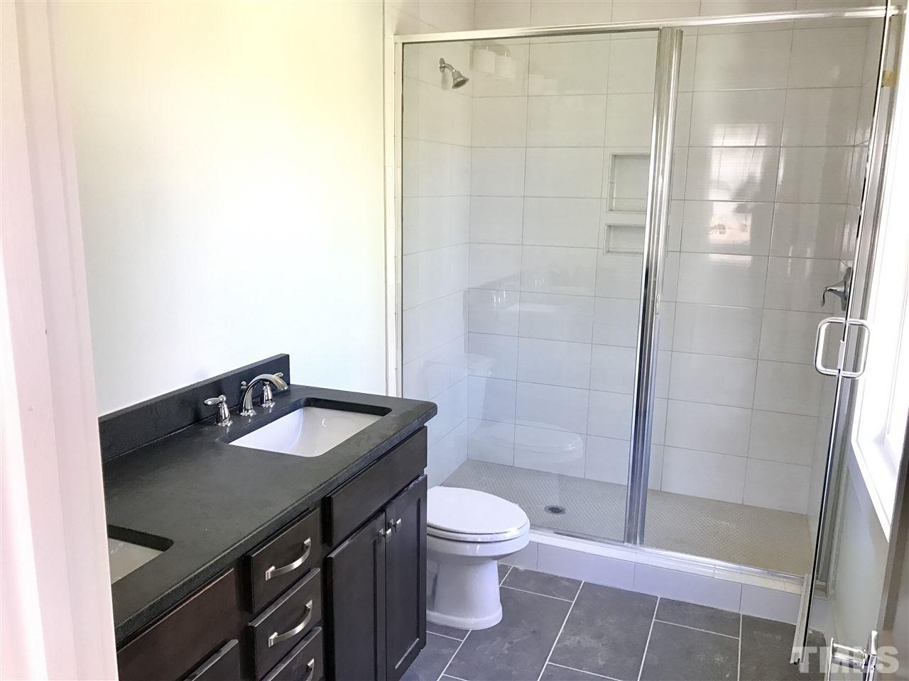 809 East Lenoir Street Raleigh, NC 27601 - Photo 10 of 20 a bathroom with a sink a toilet and shower
