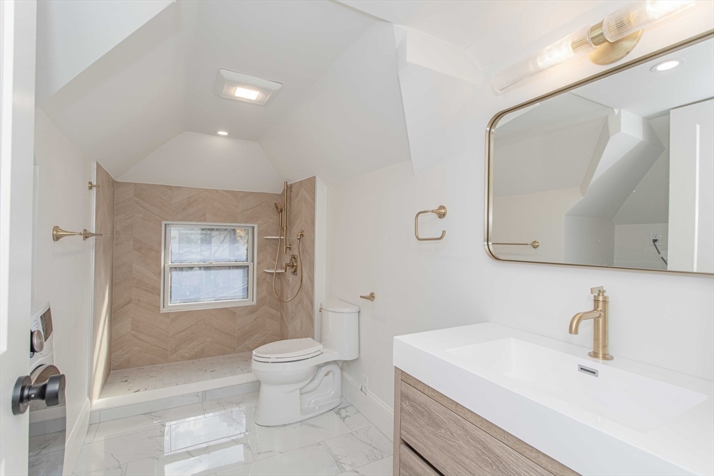 125 Mt Vernon Street, Unit 2 Newton, MA 02465 - Photo 35 of 36 a bathroom with a sink a toilet and mirror