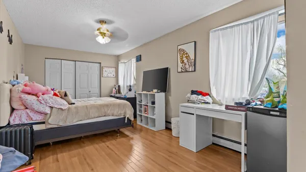 a bedroom with a bed and a chandelier
