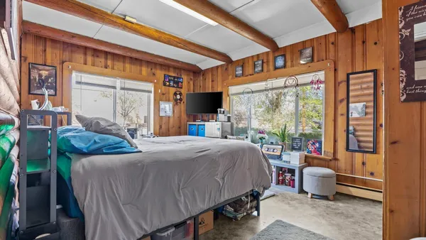 a bed room with a bed and a chair