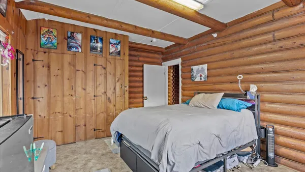 a bedroom with a bed and a painting on the wall