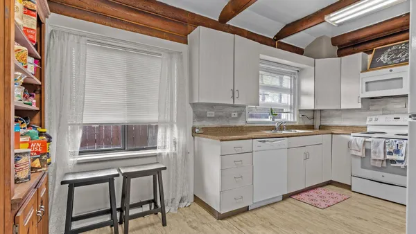 a kitchen that has a lot of cabinets in it and appliances
