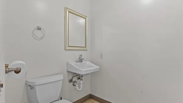 a bathroom with a sink a toilet and mirror