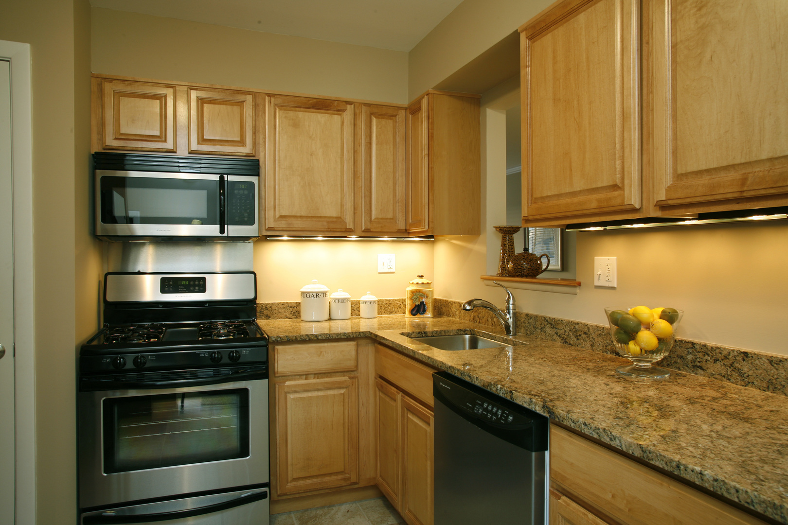 537 Ridge Road, Unit 537 Wilmette, IL 60091 - Photo 5 of 15 a kitchen with stainless steel appliances granite countertop a stove a sink and a microwave