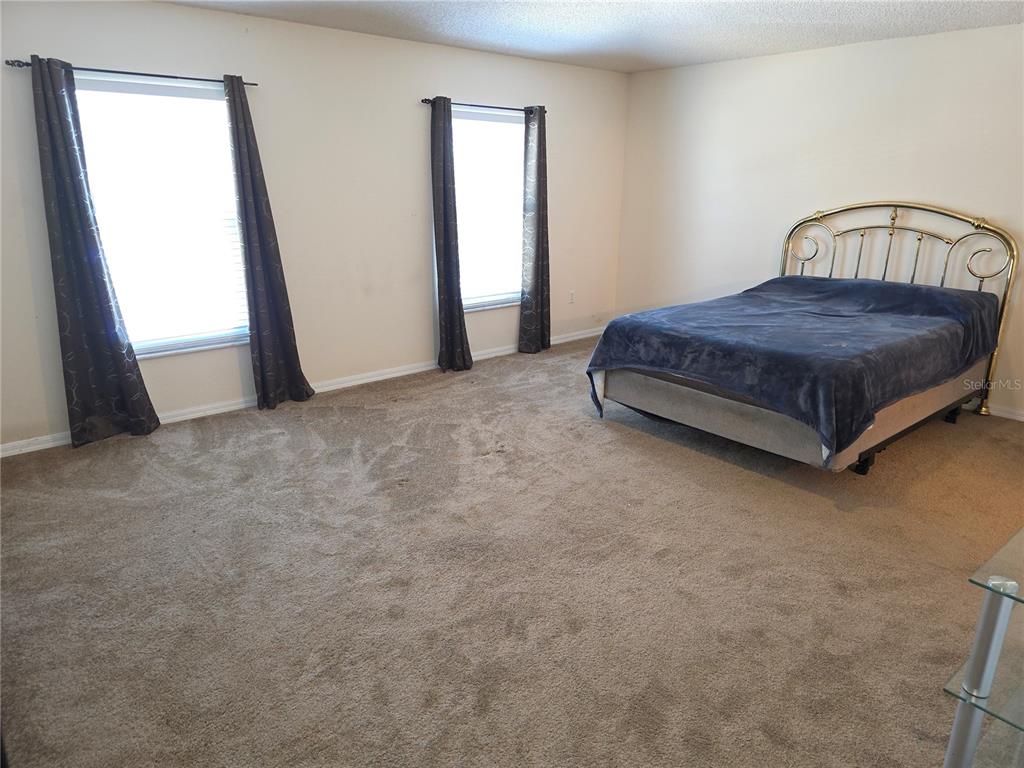 8388 Maltby Road Spring Hill, FL 34606 - Photo 11 of 28 a bedroom with a bed and a window