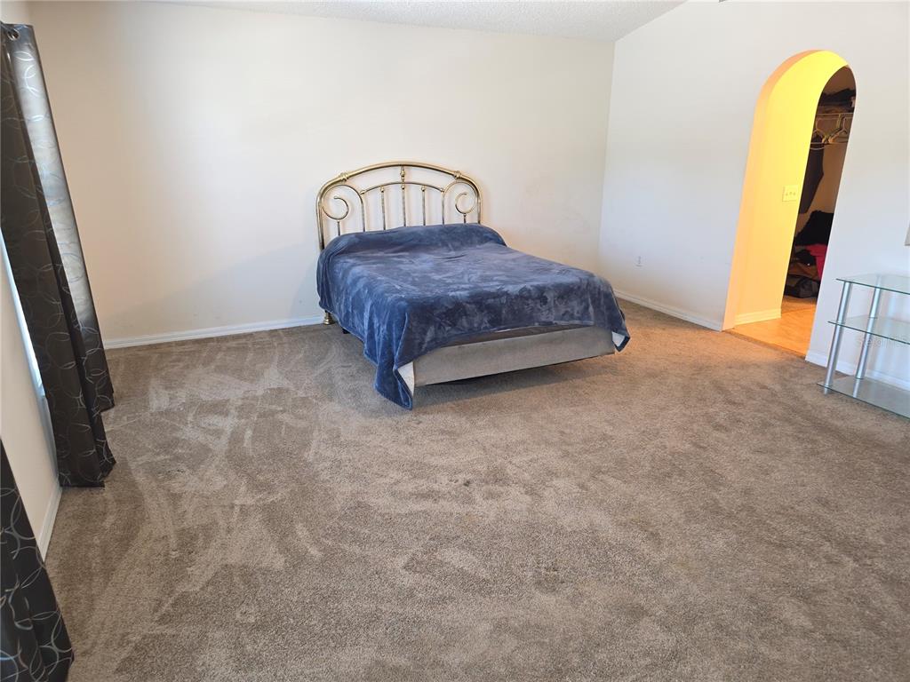 8388 Maltby Road Spring Hill, FL 34606 - Photo 12 of 28 a spacious bedroom with a bed and a dresser