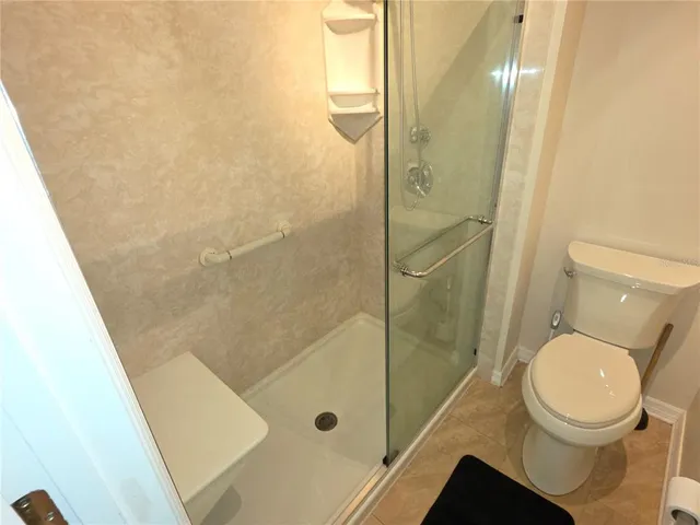a bathroom with a toilet and a shower