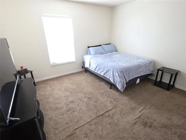 a bed sitting in a room next to a window