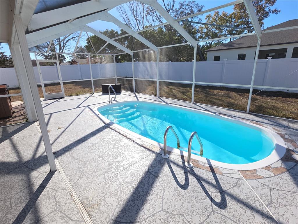 8388 Maltby Road Spring Hill, FL 34606 - Photo 23 of 28 a swimming pool with outdoor seating