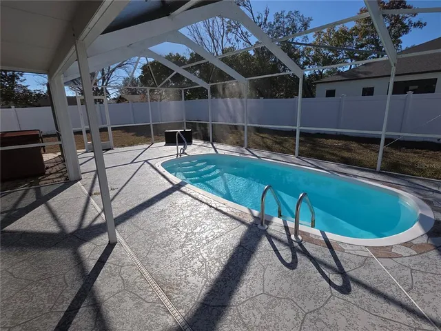 a view of a backyard with table and chairs with wooden fence