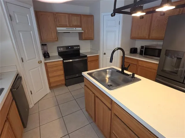a kitchen with a sink and appliances