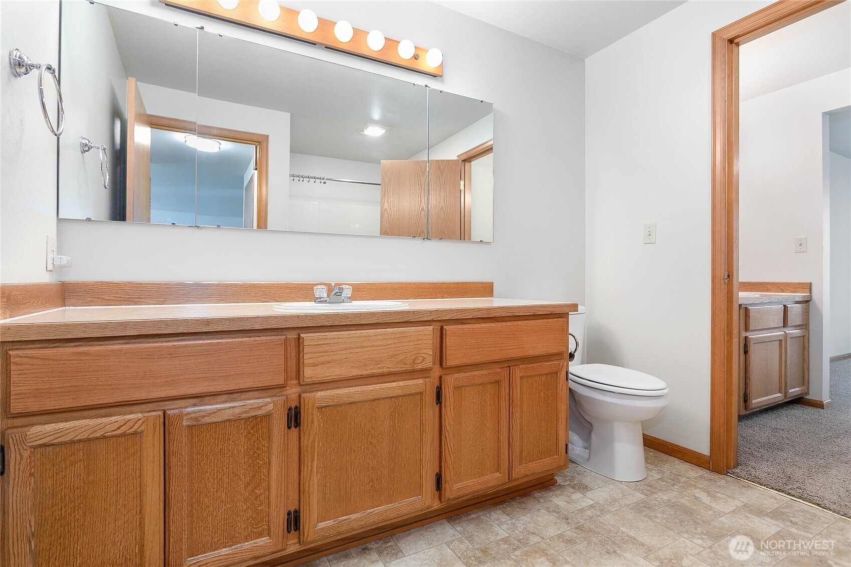 1843 Main Street, Unit G2 Lynden, WA 98264 - Photo 14 of 30 a bathroom with a toilet a sink and mirror
