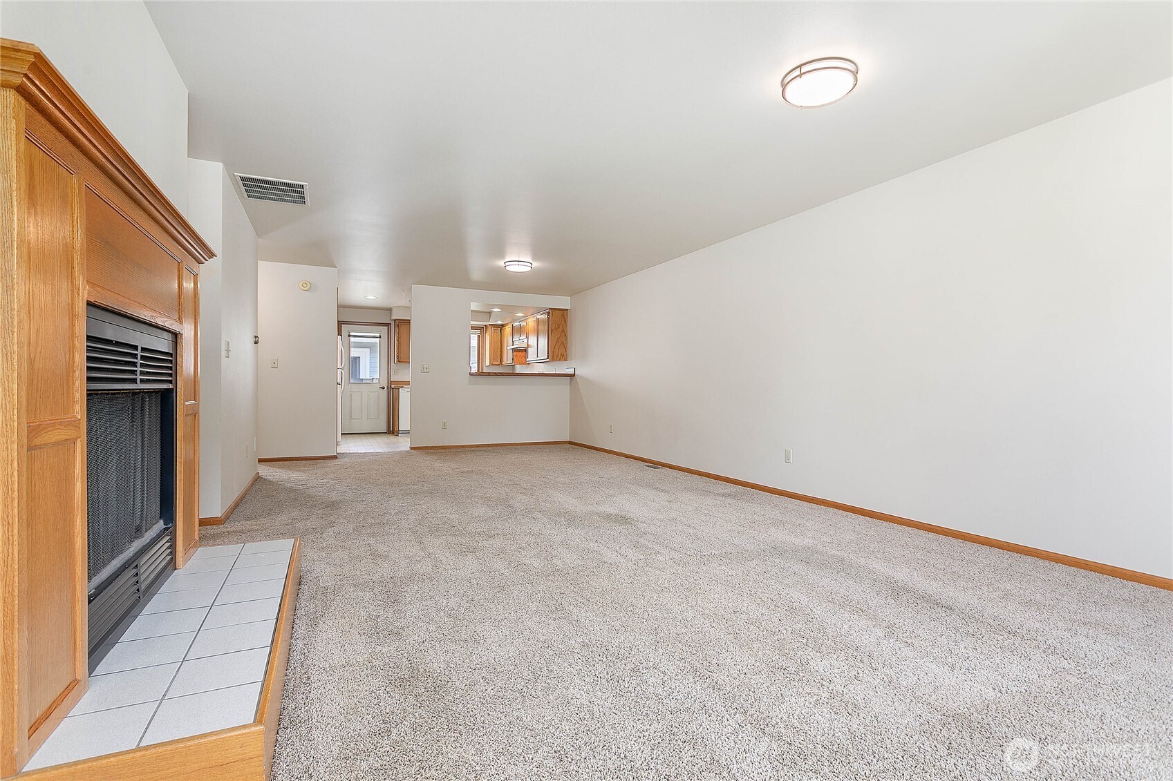 1843 Main Street, Unit G2 Lynden, WA 98264 - Photo 3 of 30 a view of an empty room with a fireplace
