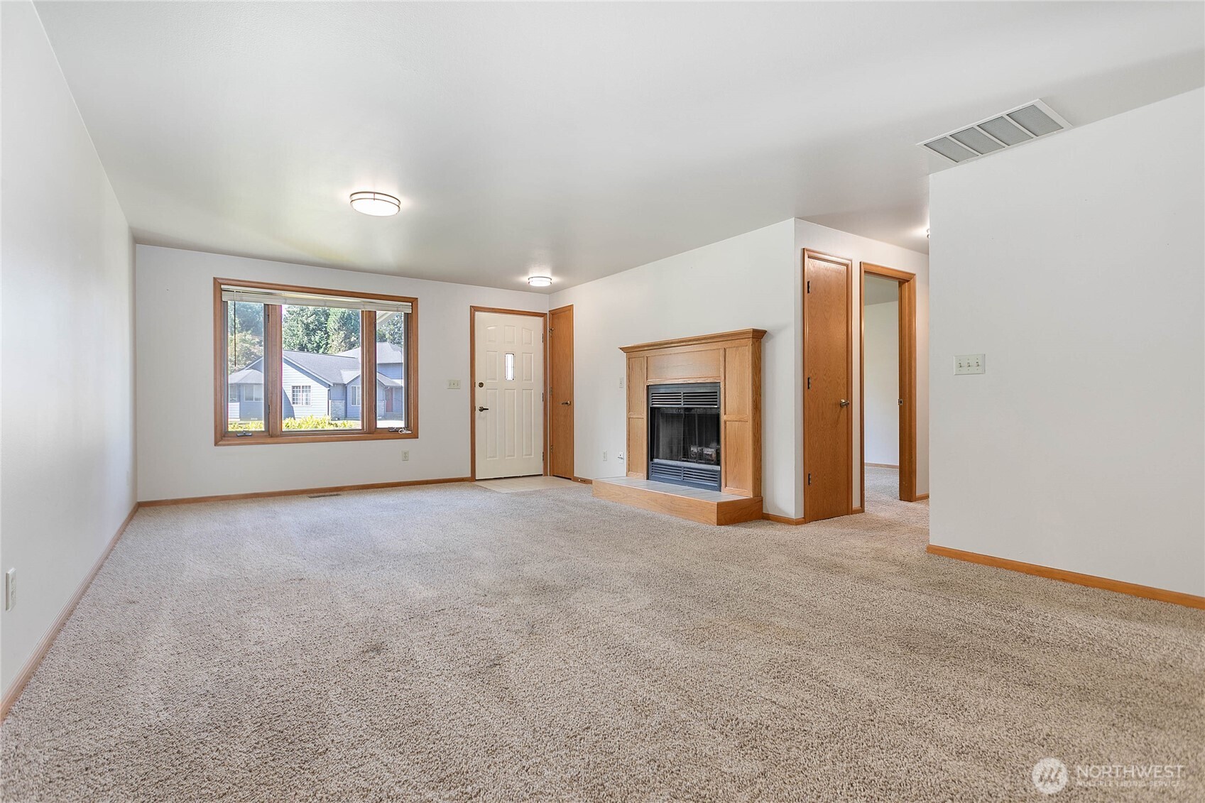 1843 Main Street, Unit G2 Lynden, WA 98264 - Photo 4 of 30 an empty room with windows and fireplace