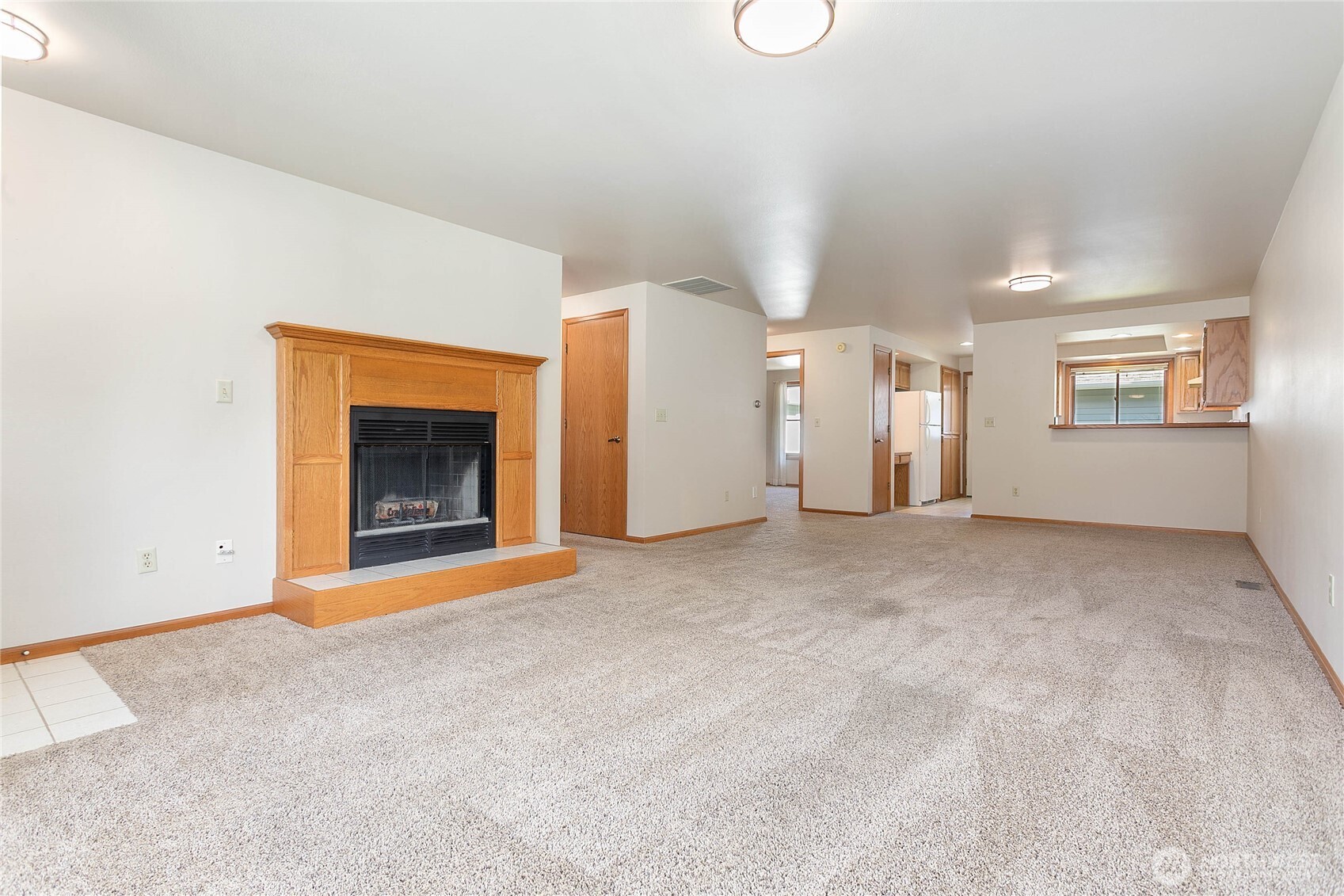 1843 Main Street, Unit G2 Lynden, WA 98264 - Photo 5 of 30 a view of an empty room with a fireplace and a window
