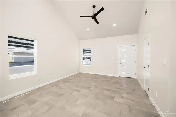 a view of a livingroom with a ceiling fan and window