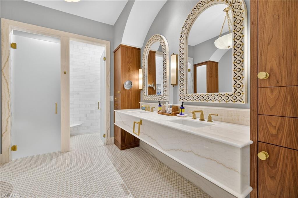 111 Caribbean Road Naples, FL 34108 - Photo 23 of 50 a en suite bathroom with a double vanity sink and a mirror